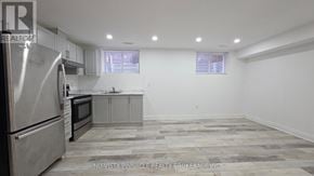 London North (North C) house for rent - A kitchen with a refrigerator, oven, and cabinets.