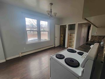 Trenton apartment for rent - A kitchen with a stove and a window.