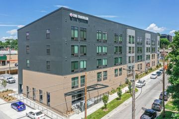 Omaha apartment for rent - A modern building with the sign "The Traveler" on the top left corner.