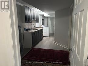 Whitchurch-Stouffville (Stouffville) house for rent - A kitchen with a sink and a refrigerator in a house.