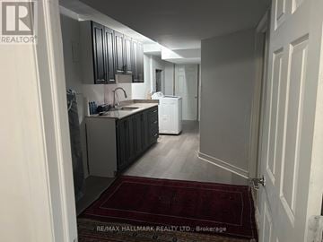 Whitchurch-Stouffville (Stouffville) house for rent - A kitchen with a sink and a refrigerator in a house.
