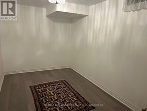 Whitchurch-Stouffville (Stouffville) house for rent - A room with a rug on the floor and a chandelier hanging from the ceiling.