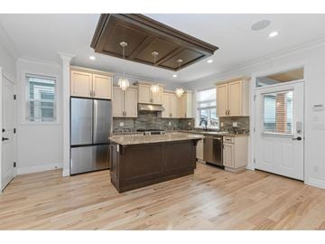 Surrey house for rent - A kitchen with wooden floors and a center island.