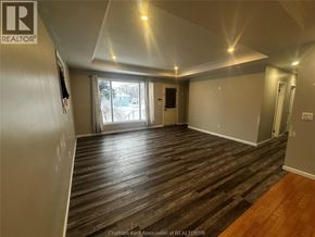 Merlin house for rent - A room with wood flooring and a slanted ceiling.