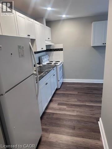 Hamilton apartment for rent - A kitchen with white cabinets and a white fridge.