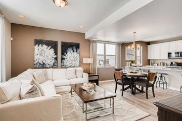 Colorado Springs apartment for rent - A modern living room with a white sofa and a glass coffee table.