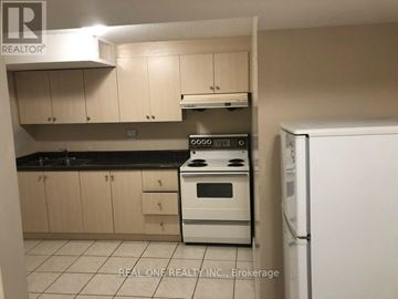 Markham (Middlefield) house for rent - A kitchen with a white stove top oven and a white refrigerator.
