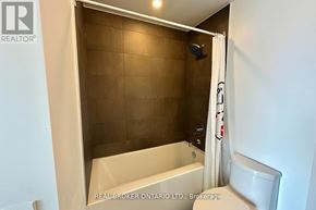 Vaughan (Vaughan Corporate Centre) condo for rent - A shower area with a brown tile wall and a white tub.