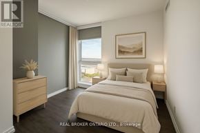 Vaughan (Vaughan Corporate Centre) condo for rent - A bedroom with a large bed, a nightstand, and a window with a view of the mountains.