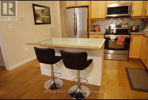 Kitchener townhouse for rent - A kitchen with a white counter top and two black bar stools.