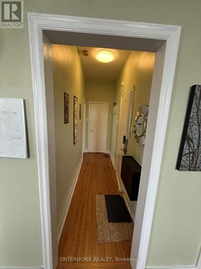 Brampton (Downtown Brampton) condo for rent - A hallway with a brokerage sign on the door.