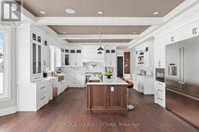 Ottawa house for rent - A large, modern kitchen with white cabinets and a wooden island.