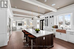 Ottawa house for rent - A modern kitchen with a large island and bar stools.