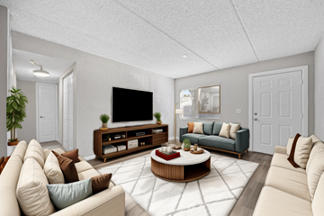 Jacksonville apartment for rent - A living room with a large television and a coffee table in the center.
