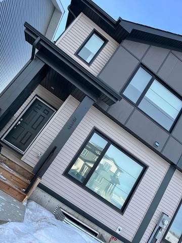Leduc apartment for rent - A house with a grey and brown exterior and a black roof.