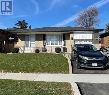 Toronto (Eglinton East) house for rent - A black car is parked in front of a house with a garage.