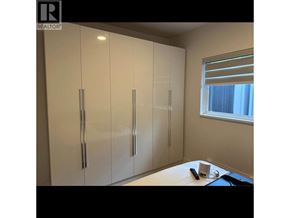 Coquitlam house for rent - A white cabinet with a glass top is in a room.