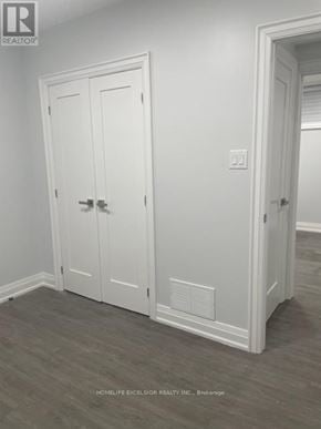 Toronto (Birchcliffe-Cliffside) house for rent - A room with a window covered by white blinds and wooden flooring.