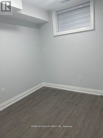 Toronto (Birchcliffe-Cliffside) house for rent - A modern kitchen with white cabinets and a central island.