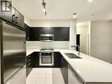 Vancouver apartment for rent - A modern kitchen with black cabinets and stainless steel appliances.