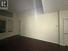 Vancouver apartment for rent - A room with a white wall and a door on the right side.