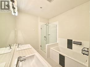Vancouver apartment for rent - A white bathroom with a glass shower door and a white bathtub.