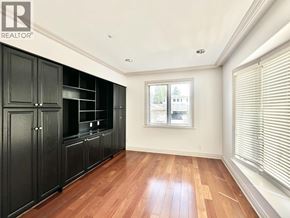 Vancouver house for rent - A room with wooden floors and black cabinets.
