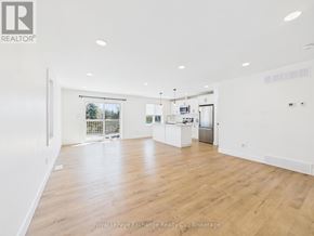 Kincardine house for rent - A kitchen with white cabinets and a wooden floor.