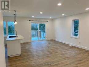 Kincardine house for rent - A spacious room with wooden flooring and a large window.