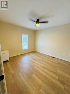 Niagara Falls house for rent - A room with a ceiling fan and wooden flooring.