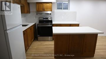 Mississauga (Meadowvale) house for rent - A kitchen with wooden cabinets and a white refrigerator.