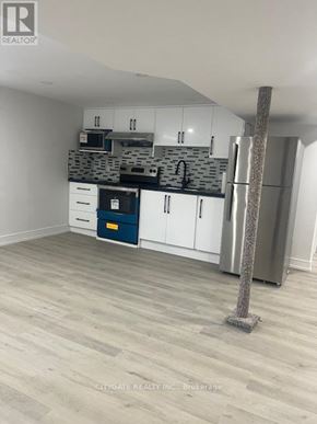 Toronto (Cliffcrest) house for rent - A kitchen with white cabinets and a blue drawer.