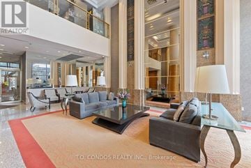 Toronto (Bay Street Corridor) condo for rent - A large, modern living room with a glass table and a red carpet.