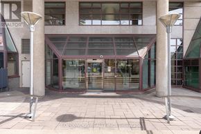 Toronto (Bay Street Corridor) condo for rent - A building entrance with a glass door and two pillars on either side.