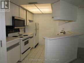 Toronto (Bay Street Corridor) condo for rent - A white kitchen with a black stove top oven.