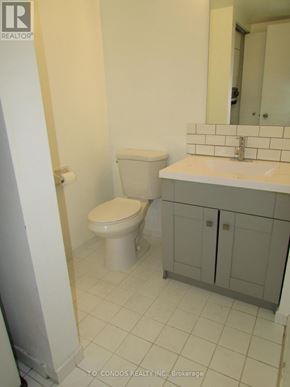 Toronto (Bay Street Corridor) condo for rent - A white toilet sits next to a sink in a small bathroom.