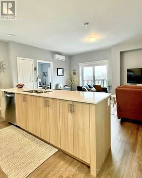 Ottawa condo for rent - A kitchen with wooden cabinets and a countertop.