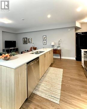 Ottawa condo for rent - A modern kitchen with wooden cabinets and a white countertop.