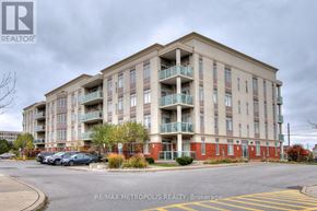 Markham (Middlefield) condo for rent - A large apartment building with a parking lot in front.