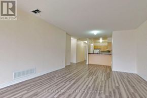 Markham (Middlefield) condo for rent - A spacious room with wooden flooring and white walls.