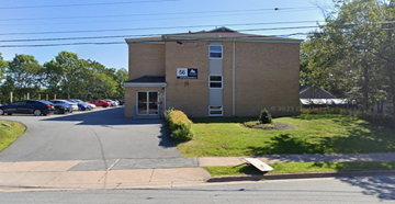 Halifax apartment for rent - A building with the number 56 on it is surrounded by a parking lot.