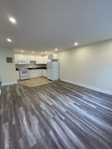 Halifax apartment for rent - A kitchen with white cabinets and a microwave is visible through a glass door.