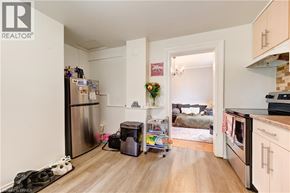 Brantford house for rent - A kitchen with a refrigerator, a dishwasher, and a stove top oven.