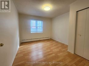 For rent in Kitchener - A room with wooden flooring and a window with blinds.