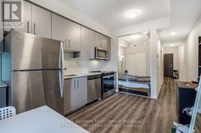 Hamilton (Central) condo for rent - A kitchen with a refrigerator, microwave, oven and sink.