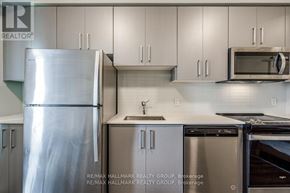 Hamilton (Central) condo for rent - A kitchen with a refrigerator, microwave, and oven.