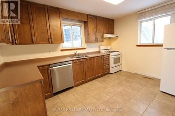 Richmond Hill (North Richvale) house for rent - A kitchen with wooden cabinets and a white refrigerator.