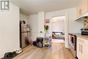 Brantford house for rent - A kitchen with a refrigerator, a microwave, and a dishwasher.
