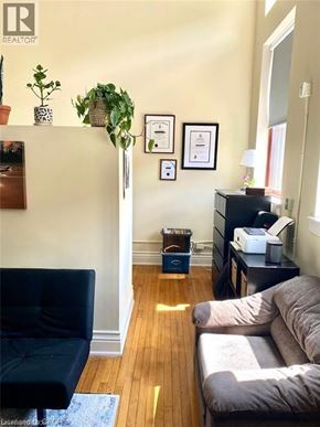 Hamilton condo for rent - A living room with a black chair and a grey couch.