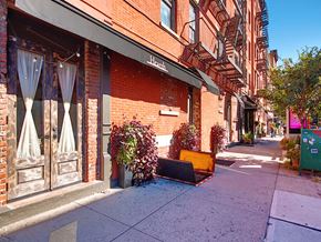 New York apartment for rent - a piece of furniture sitting on the sidewalk in front of a building
